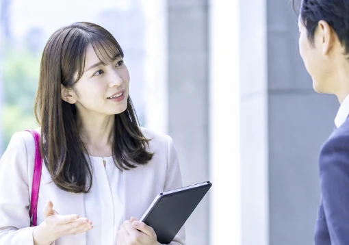 A sales rep explaining to a customer with a tablet