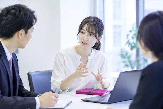 Three people meeting in a conference room